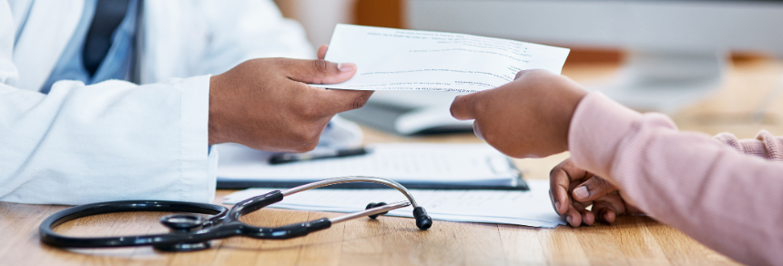 A doctor passes a sick note to a patient